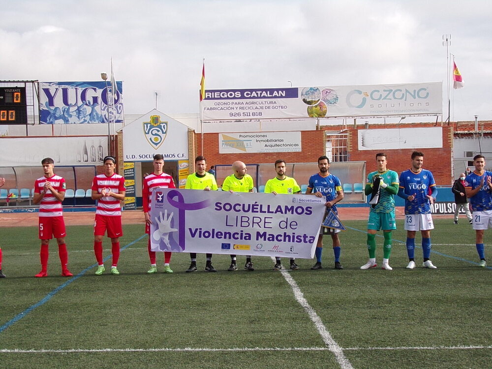 Los dos equipos posaron con una pancarta contra la violencia de género.
