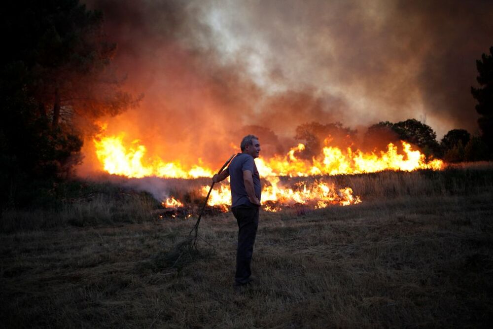 A man looks on as a wildfire burns in Verin  / FELIPE CARNOTTO
